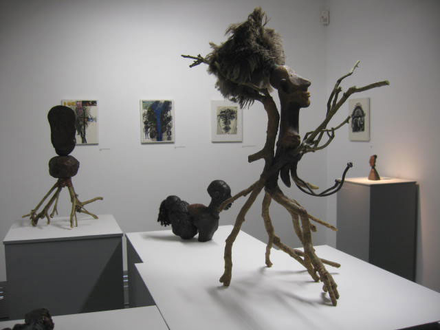 Foreground - Princess Mosquito 2002, wax, tree branches, feathers.